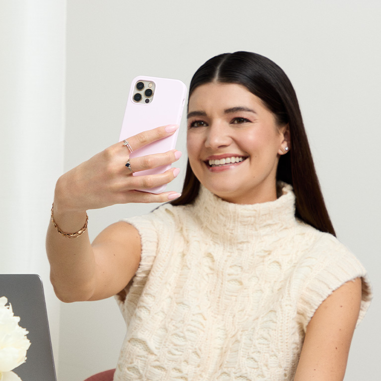 A woman is trying out the foundation matching tool on her phone.