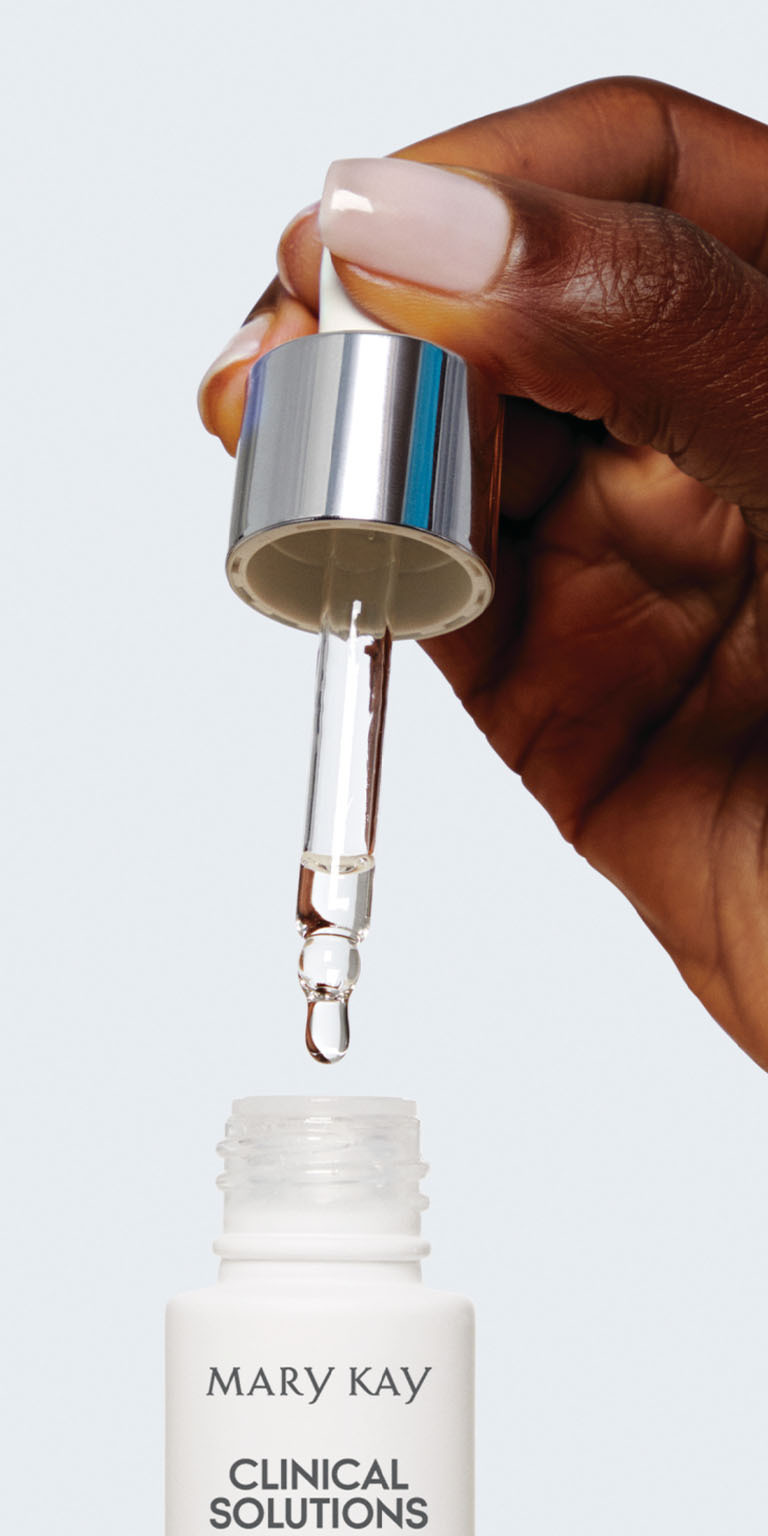 Model holding Clinical Solutions C + Resveratrol Line-Reducer bottle and dropper