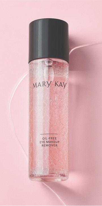Bottle of Mary Kay Oil Free Eye Makeup Remover shaken up on a pink background